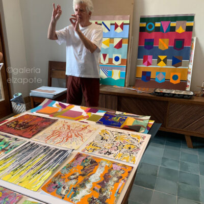 Stephen Aiken in his Mérida studio surrounded by abstract paintings from the “Banderas” series.