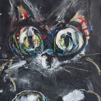 Front-facing black cat with green, blue, and red eyes, dark background, and inverted white letters drawn with crayon and paint